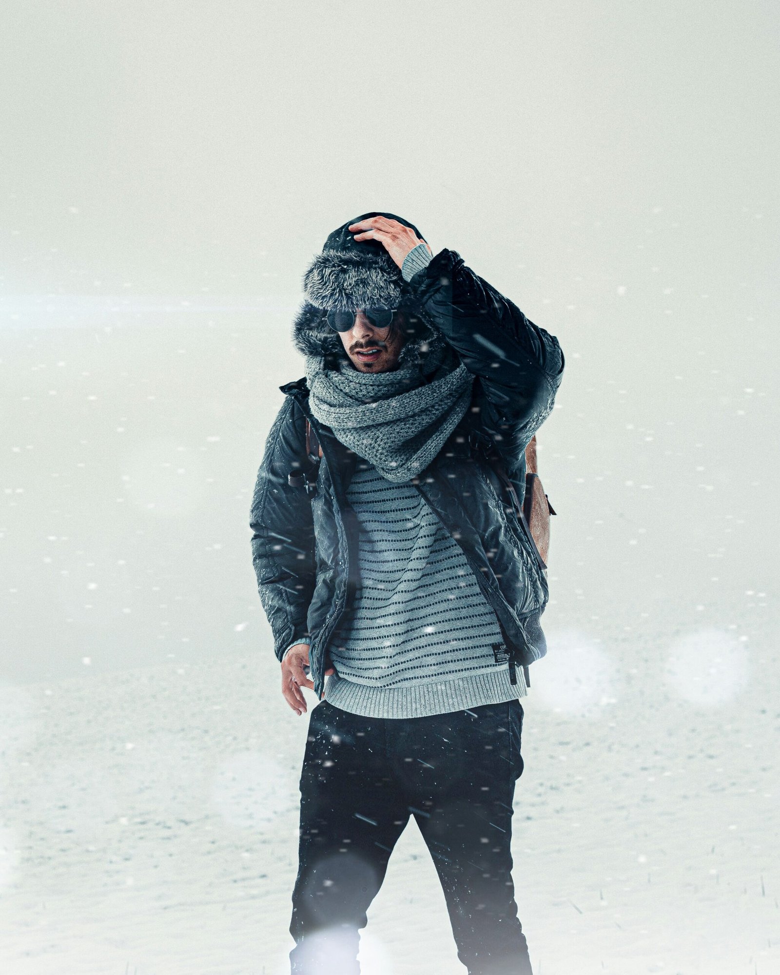 woman in black jacket and black pants standing on snow covered ground